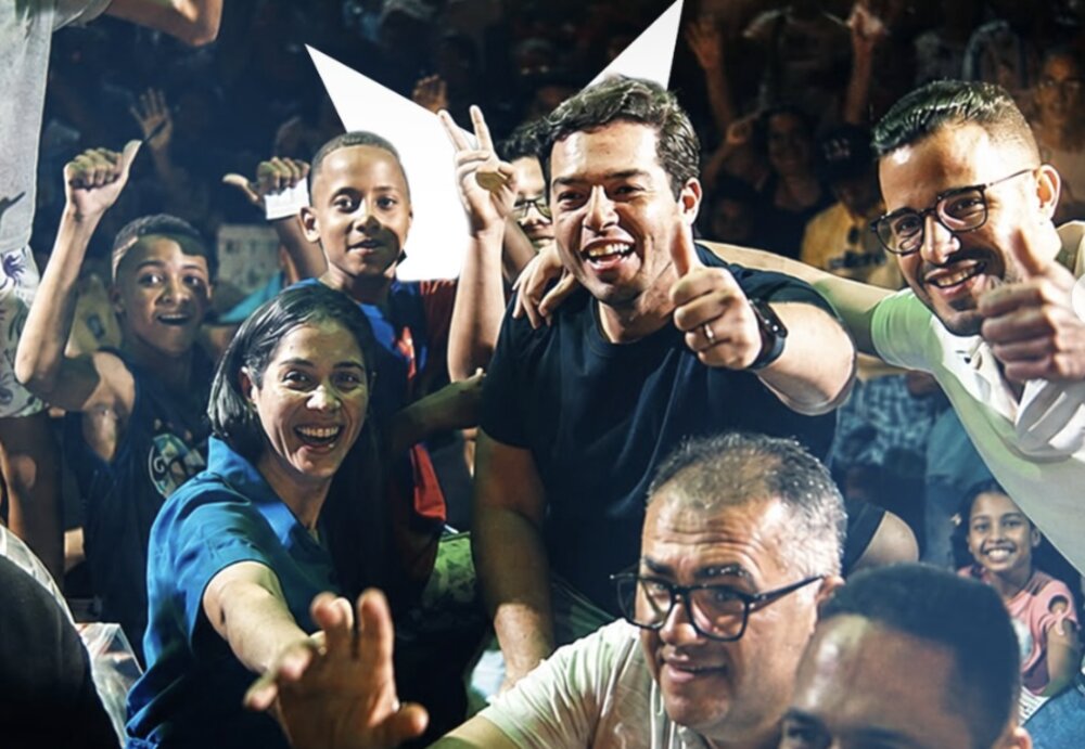 Túlio Arruda cercado pelo público em ato de rua, celebrando com apoiadores